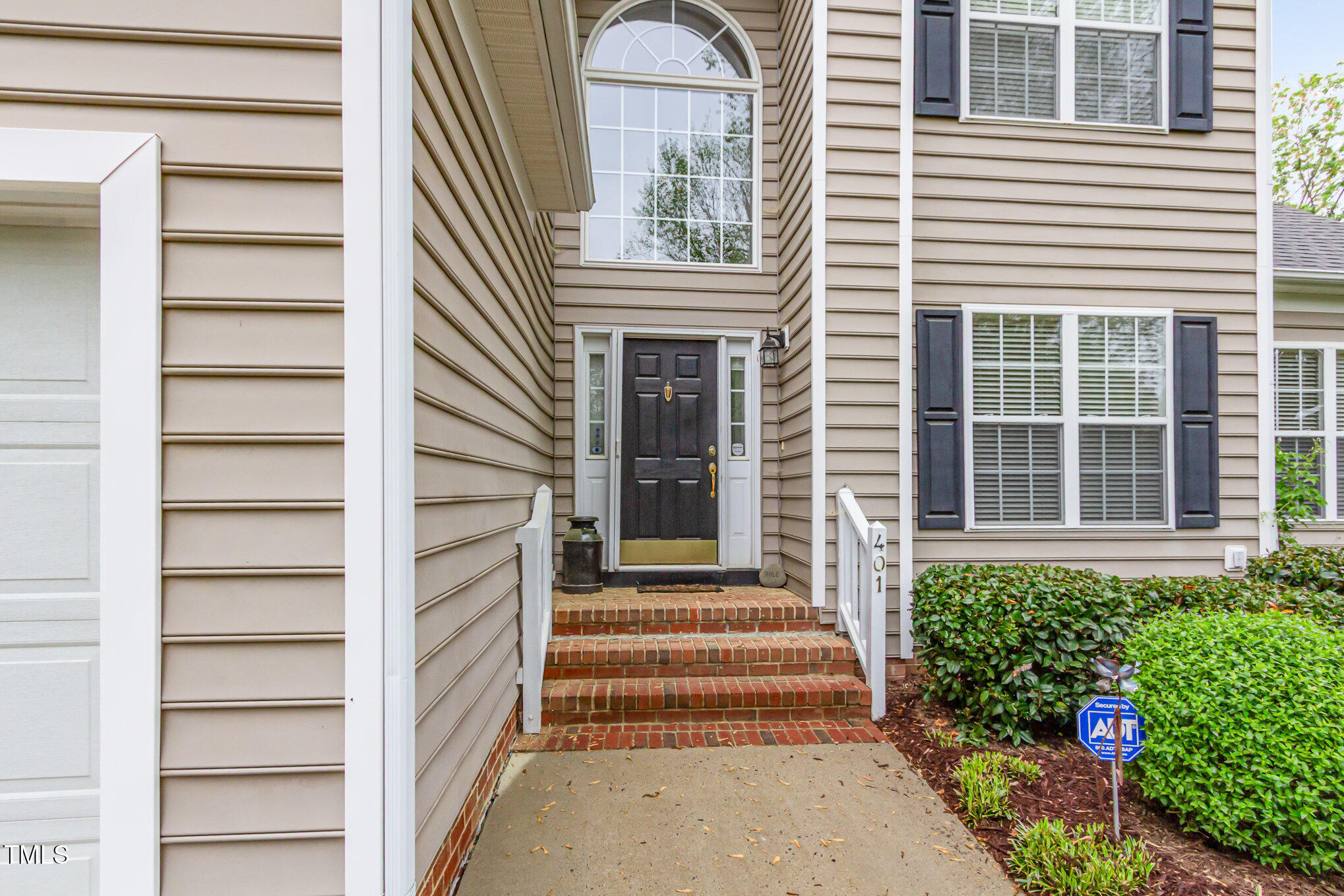 401 Stinhurst Drive Durham, NC 27713 - Photo 37 of 39 a front view of a house with entryway and flowers