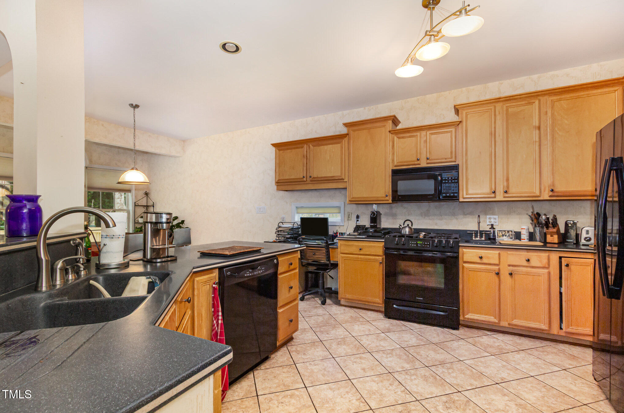 401 Stinhurst Drive Durham, NC 27713 - Photo 9 of 39 a kitchen with stainless steel appliances granite countertop a sink dishwasher stove top oven and cabinets