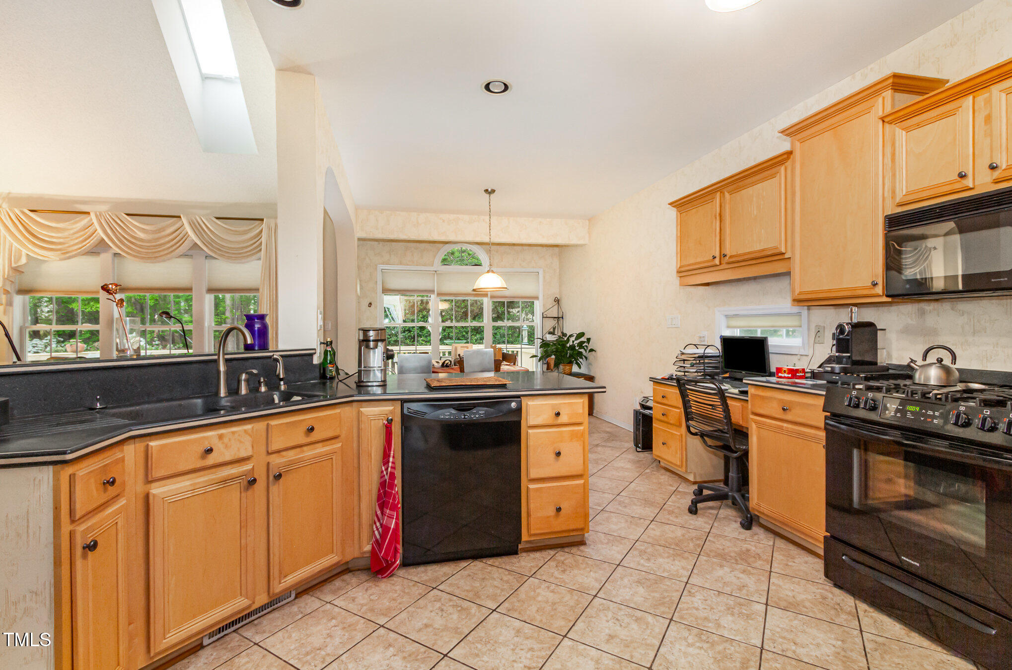 401 Stinhurst Drive Durham, NC 27713 - Photo 10 of 39 a kitchen with stainless steel appliances granite countertop a stove a sink and a microwave
