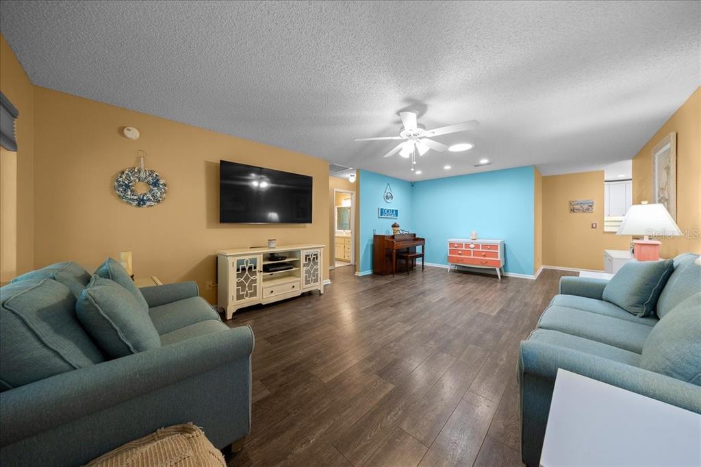 8720 Southwest 90th Street, Unit A Ocala, FL 34481 - Photo 12 of 71 a living room with furniture and a flat screen tv