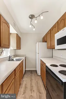 a kitchen with a stove sink and a refrigerator