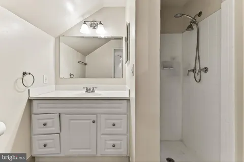 a bathroom with a sink vanity and a mirror