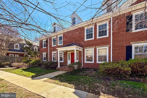 a view of a brick building next to a yard