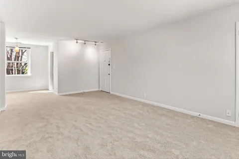 an empty room with windows and closet