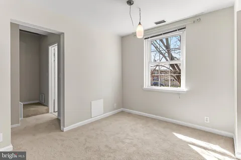 an empty room with windows and closet
