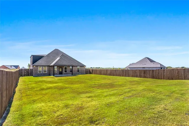 a view of a house with swimming pool and a yard