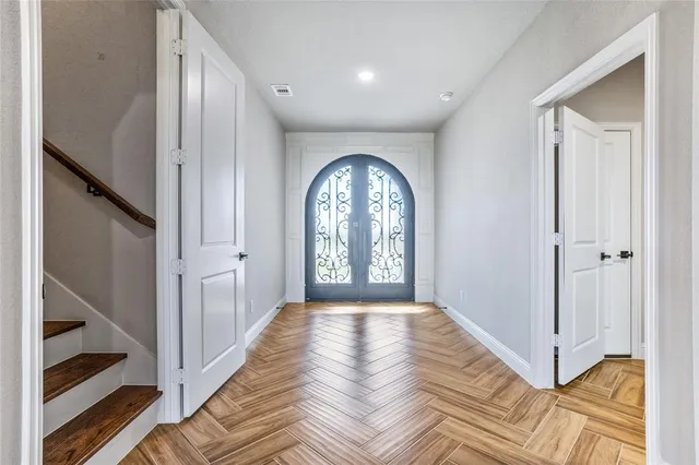 a view of a hallway with entryway wooden floor and front door