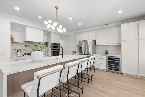 a kitchen with kitchen island granite countertop a center island a sink stainless steel appliances and cabinets