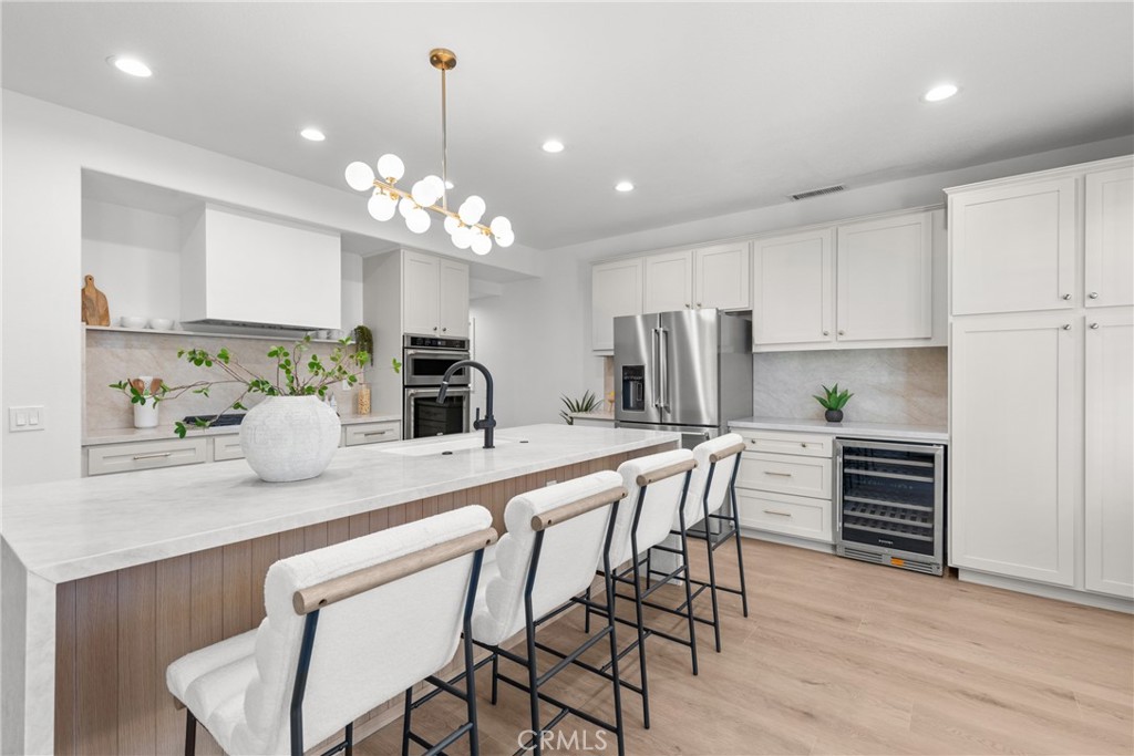 a kitchen with kitchen island granite countertop a center island a sink stainless steel appliances and cabinets
