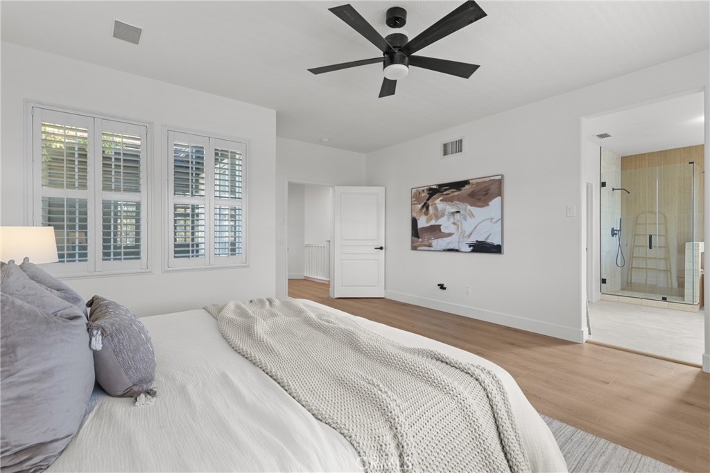 173 Parkside Drive Simi Valley, CA 93065 - Photo 15 of 31 a bedroom with a large bed and a chandelier