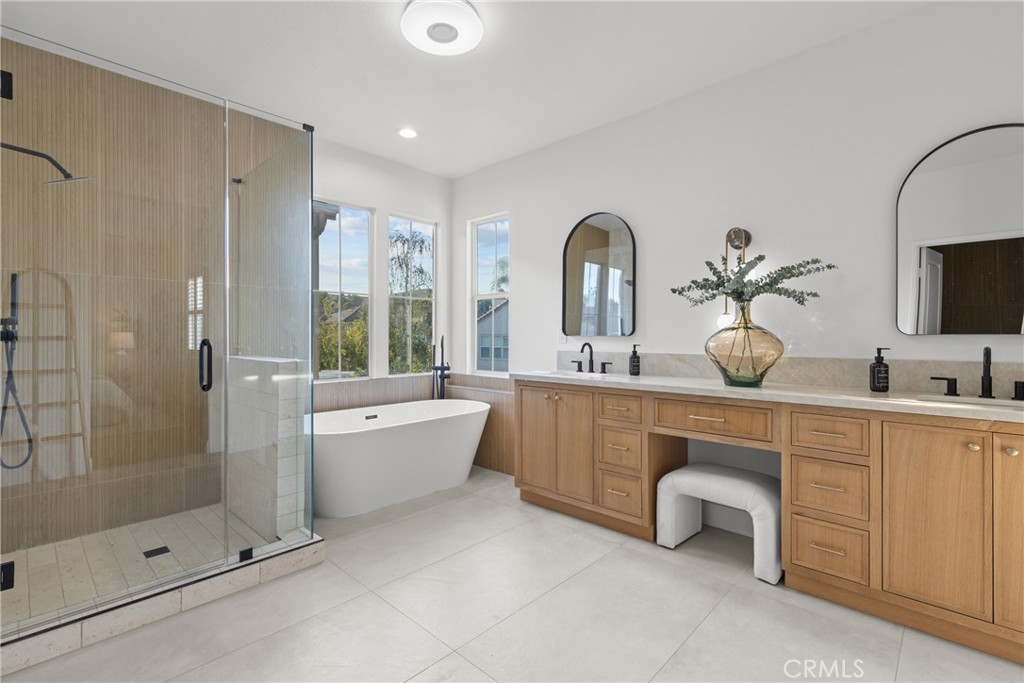 173 Parkside Drive Simi Valley, CA 93065 - Photo 16 of 31 a spacious bathroom with a double vanity sink a large mirror a shower and bathtub