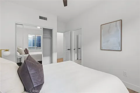 a bedroom with a large bed and chandelier