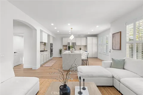 a living room with furniture and kitchen view