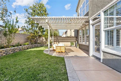 a view of a house with swimming pool and sitting area