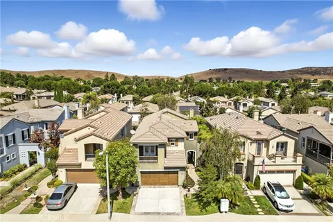an aerial view of residential houses with city view