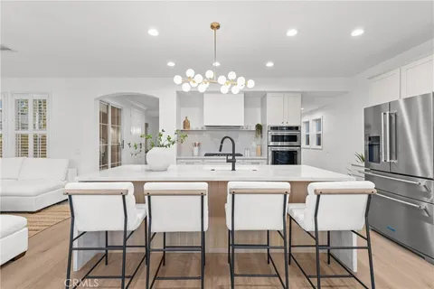 a kitchen with stainless steel appliances a white stove top oven and refrigerator