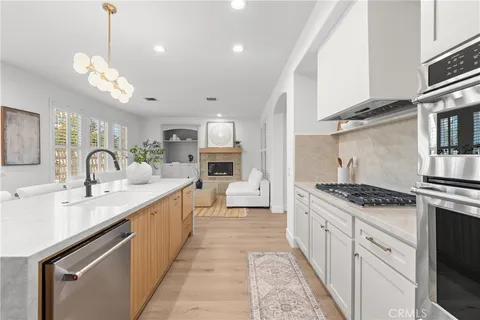 a open kitchen with stainless steel appliances granite countertop a sink and stove