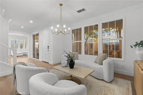 a living room with furniture and a chandelier