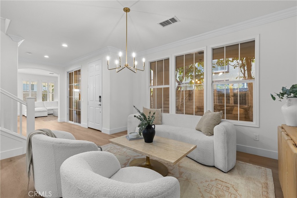 173 Parkside Drive Simi Valley, CA 93065 - Photo 10 of 31 a living room with furniture and a chandelier