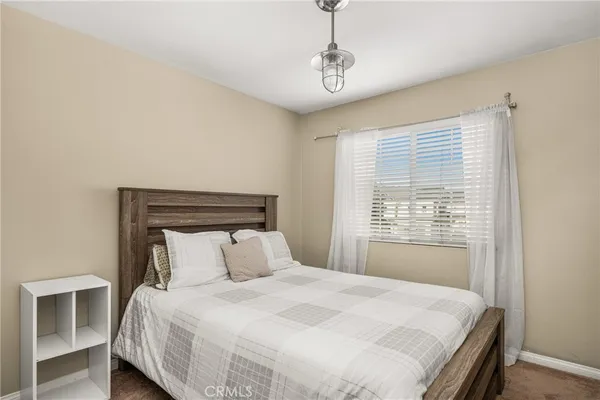 a bedroom with a bed and window
