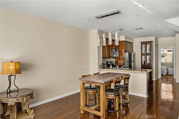a view of a dining room with furniture and wooden floor