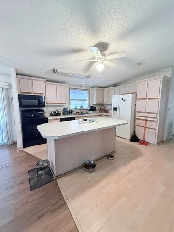 a large kitchen with stainless steel appliances lots of counter top space