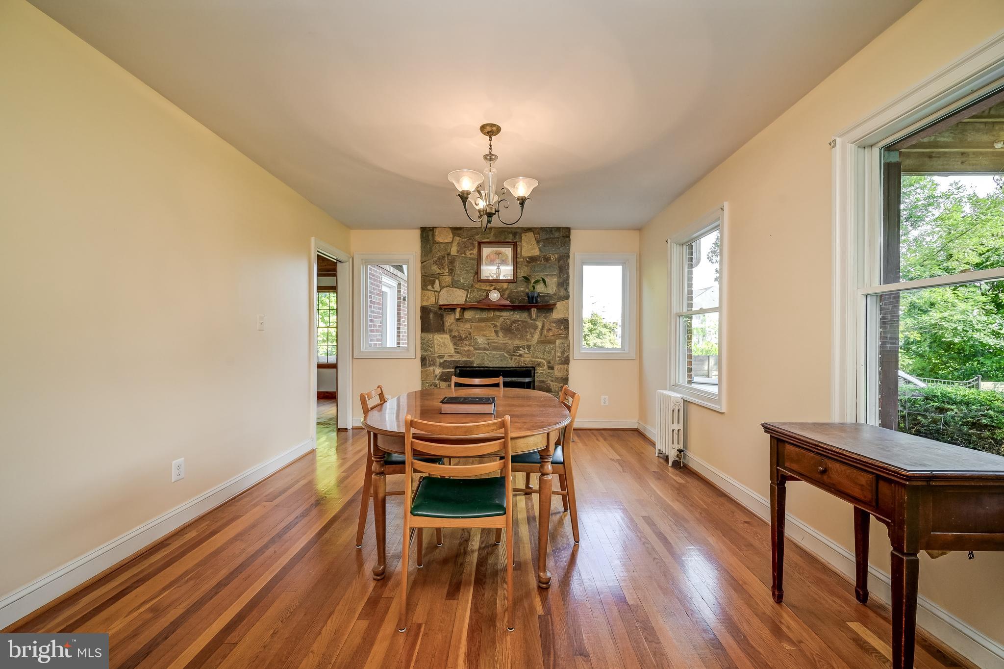 5 Lee Street Gaithersburg, MD 20877 - Photo 21 of 90 a dining room with wooden floor a chandelier a wooden table and chairs