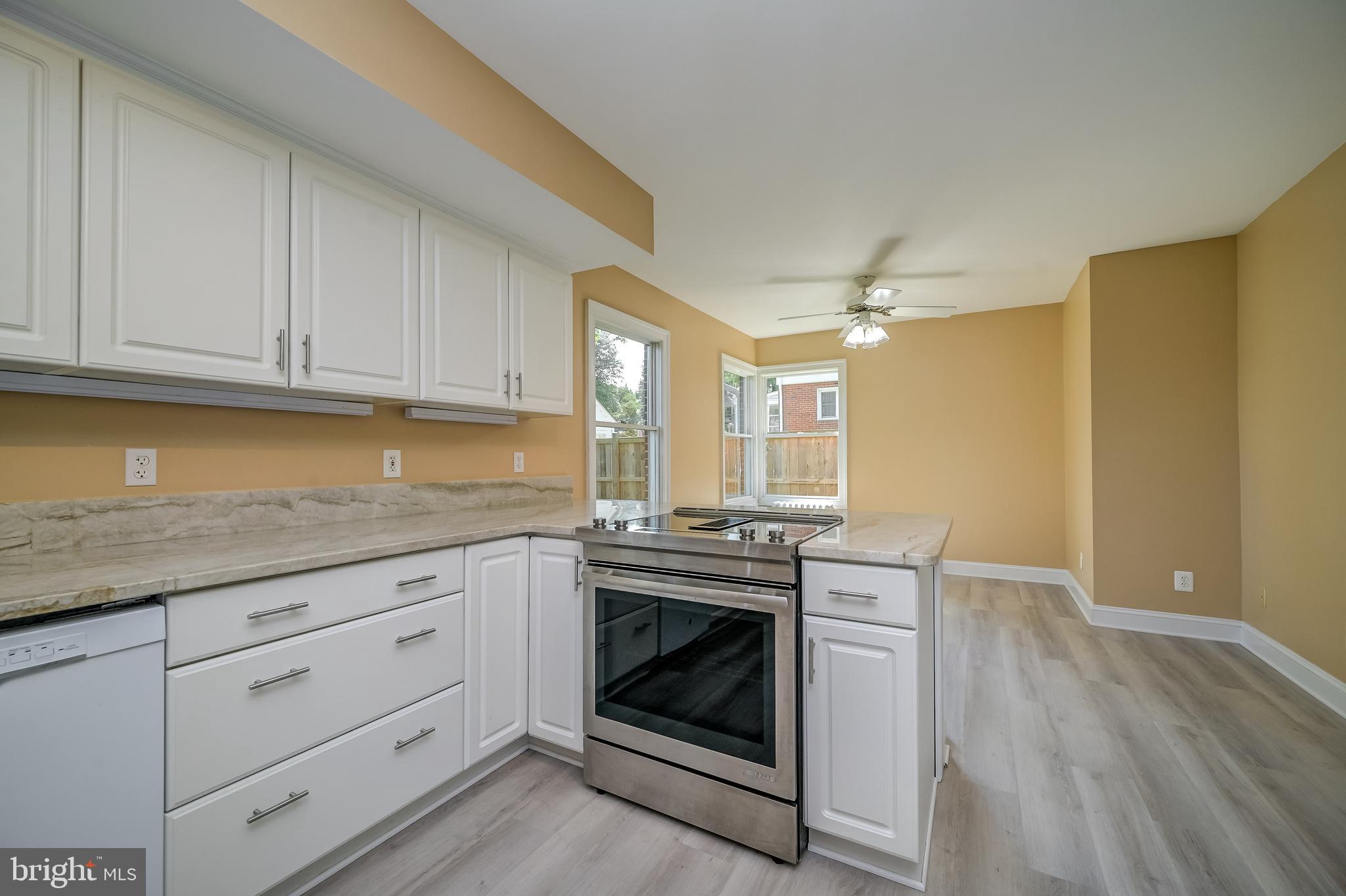5 Lee Street Gaithersburg, MD 20877 - Photo 26 of 90 a kitchen with granite countertop a stove cabinets and wooden floor