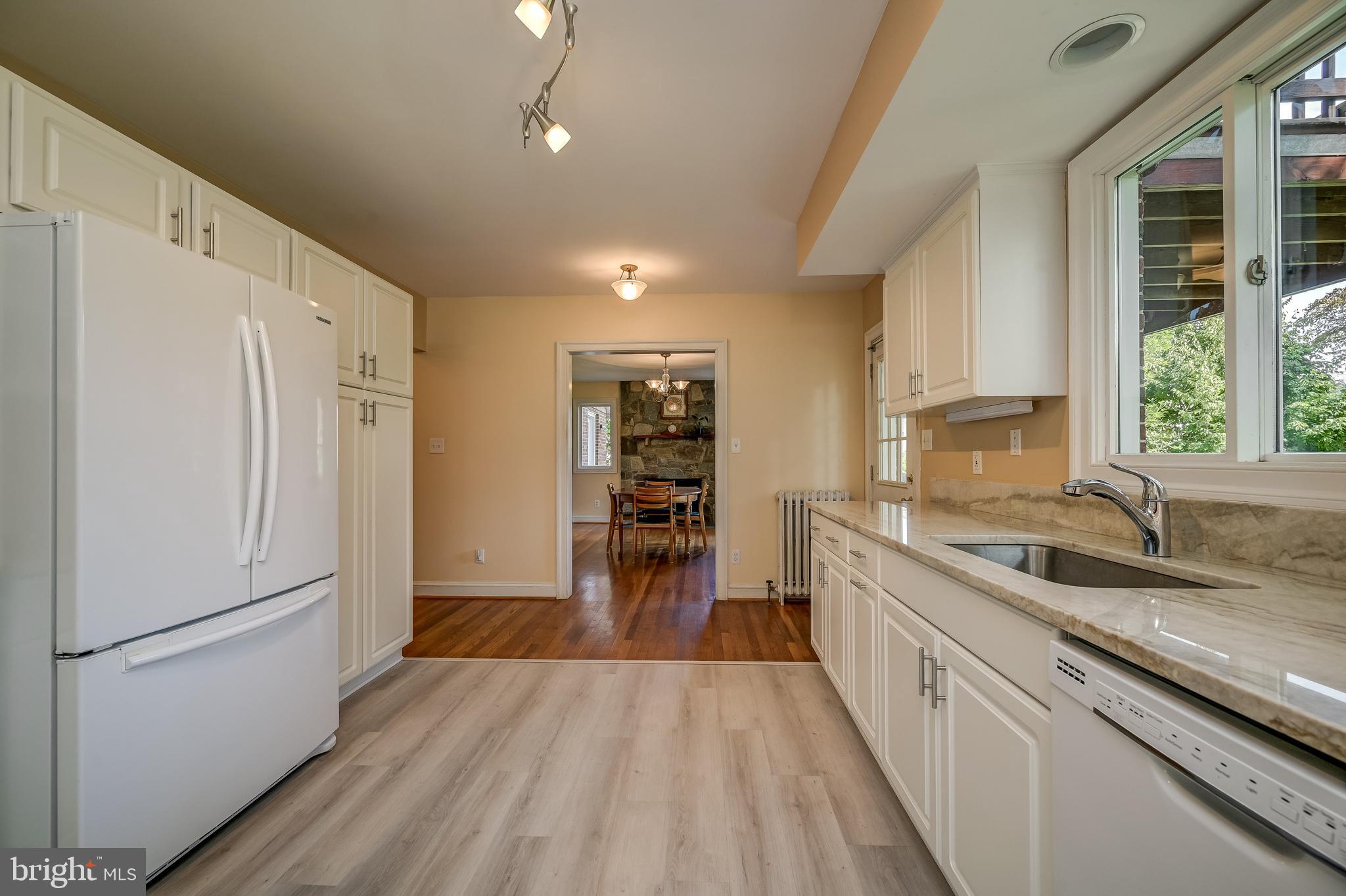 5 Lee Street Gaithersburg, MD 20877 - Photo 28 of 90 a kitchen with a refrigerator a sink and wooden floor