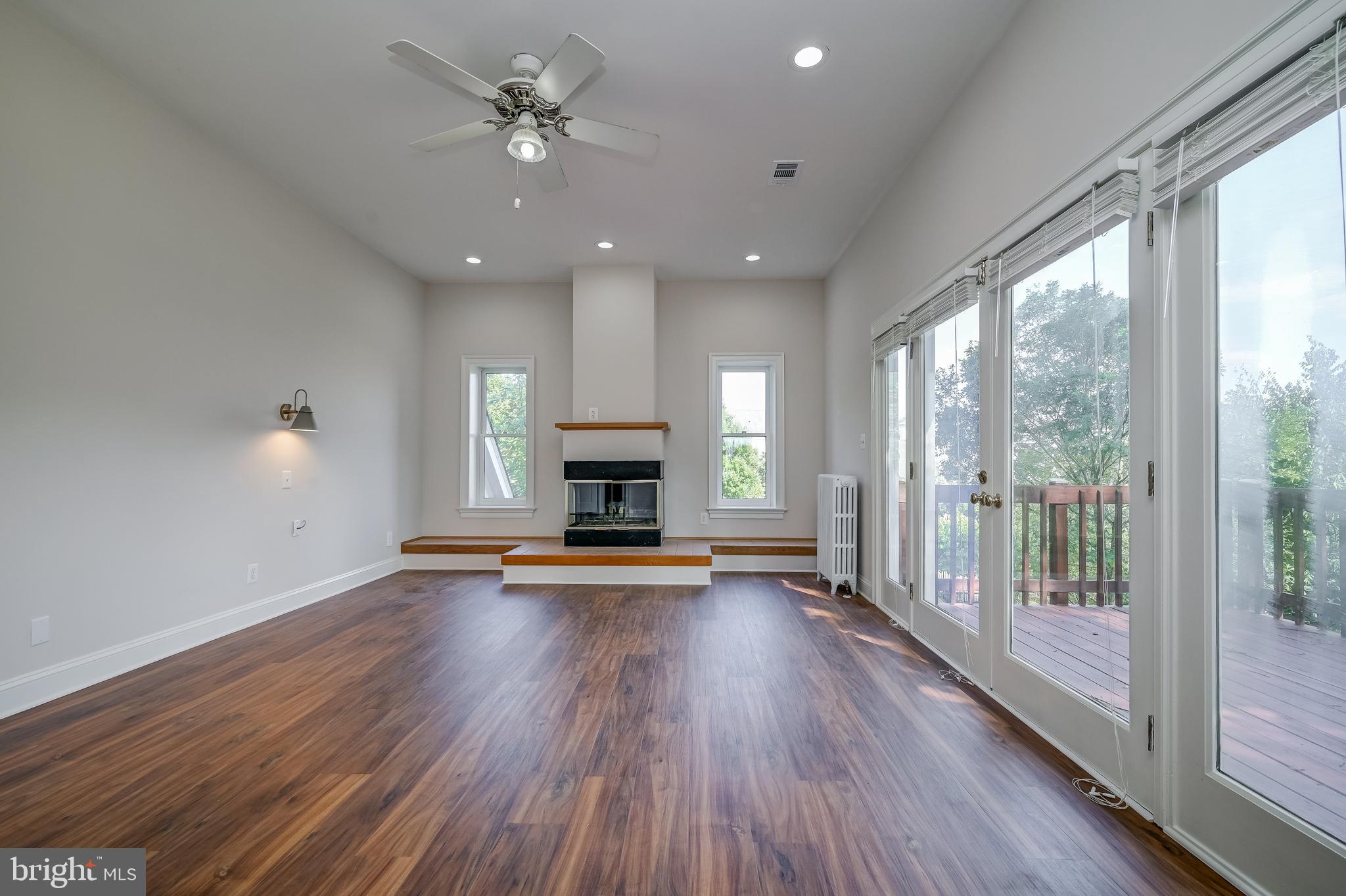 5 Lee Street Gaithersburg, MD 20877 - Photo 39 of 90 a view of empty room with fireplace and wooden floor