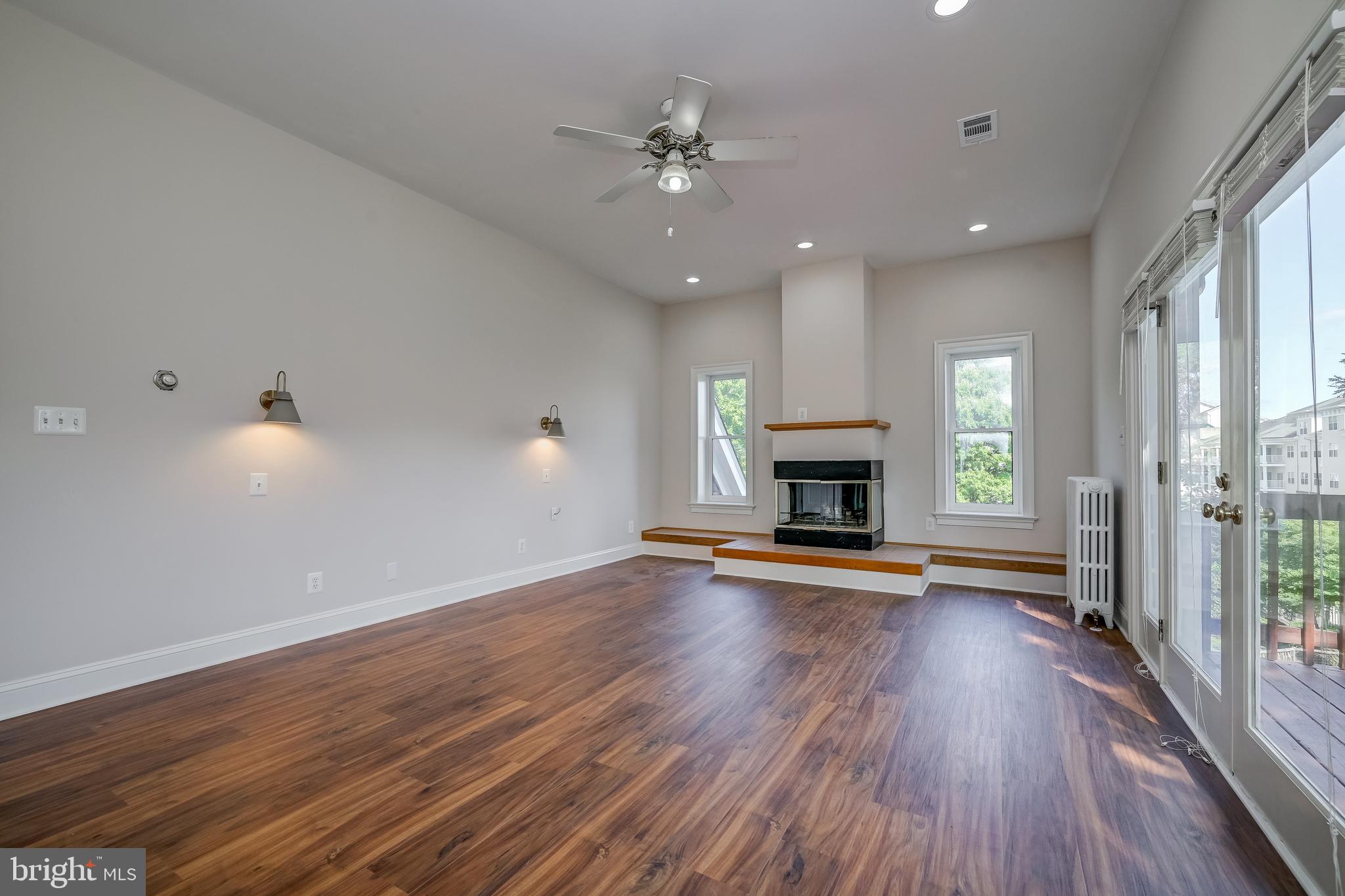5 Lee Street Gaithersburg, MD 20877 - Photo 40 of 90 an empty room with wooden floor fireplace and windows
