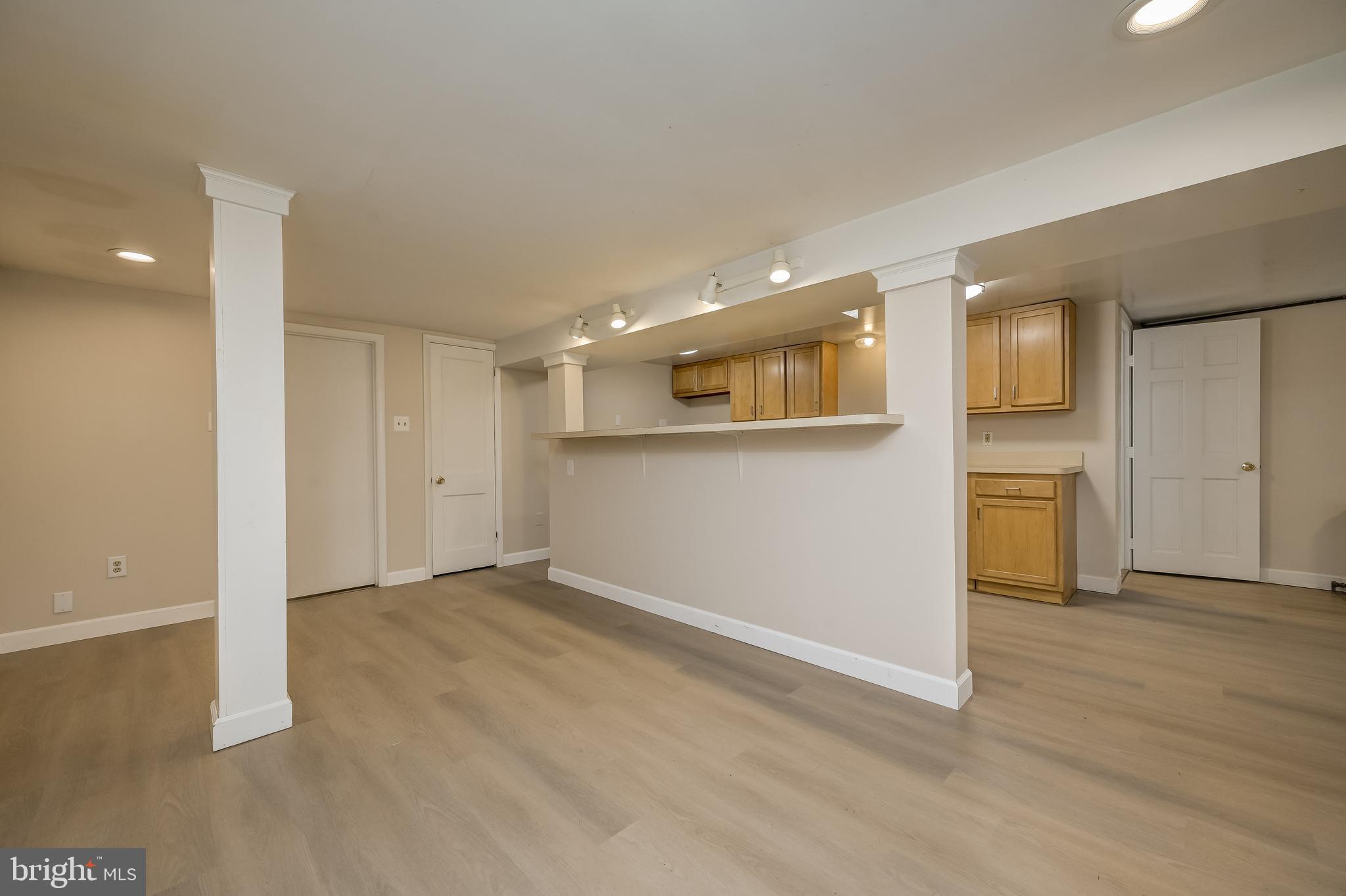 5 Lee Street Gaithersburg, MD 20877 - Photo 77 of 90 a view of empty room with wooden floor and kitchen