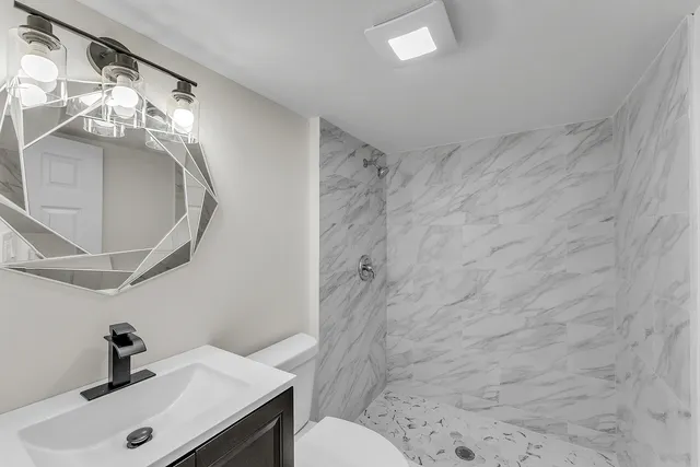 a bathroom with a sink toilet and shower