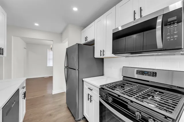 a kitchen with a stove and a microwave