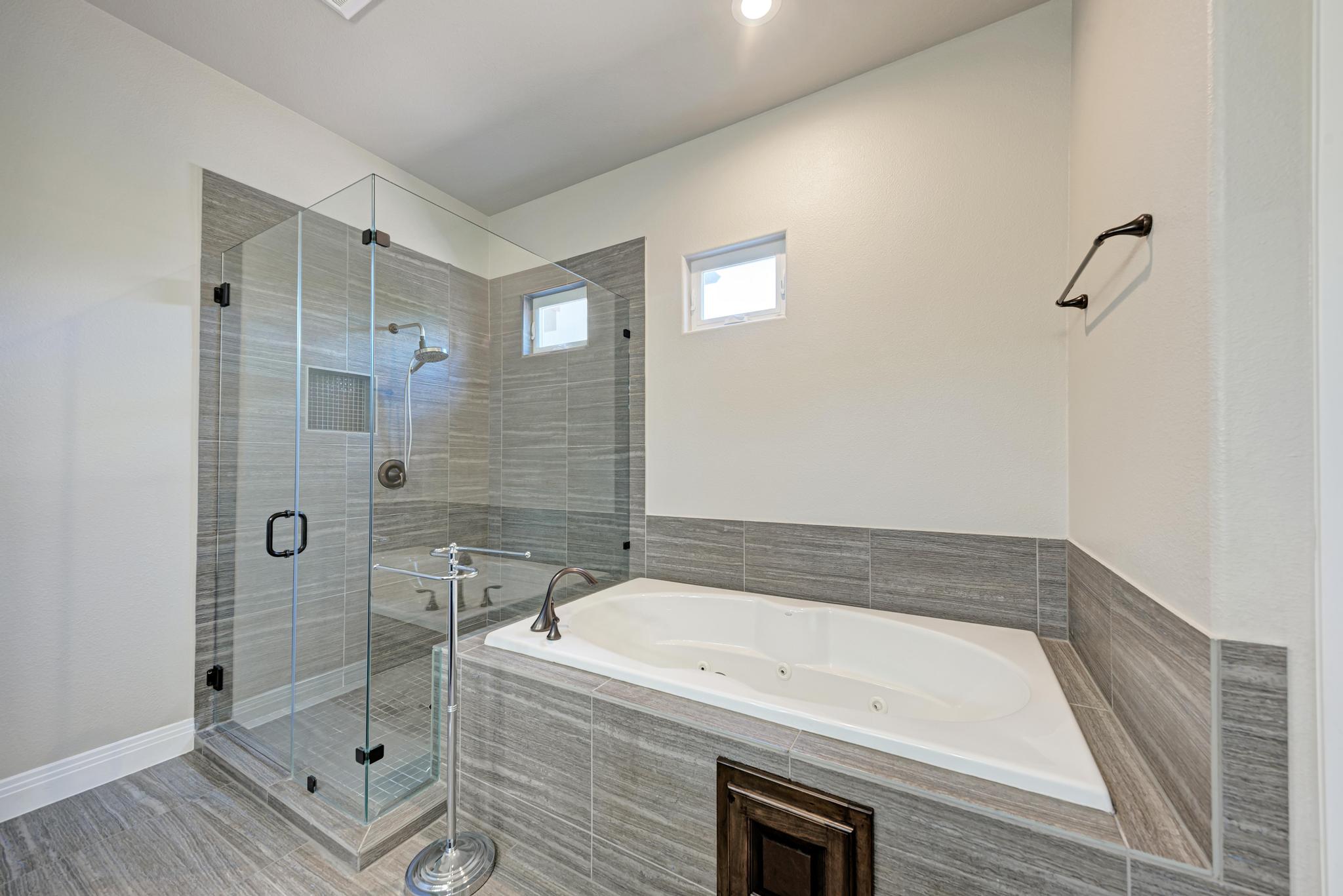 2601 North Quinlan Park Road, Unit 506 Austin, TX 78732 - Photo 26 of 39 Indulge in relaxation with this primary bathroom's spacious soaking tub and walk-in shower.