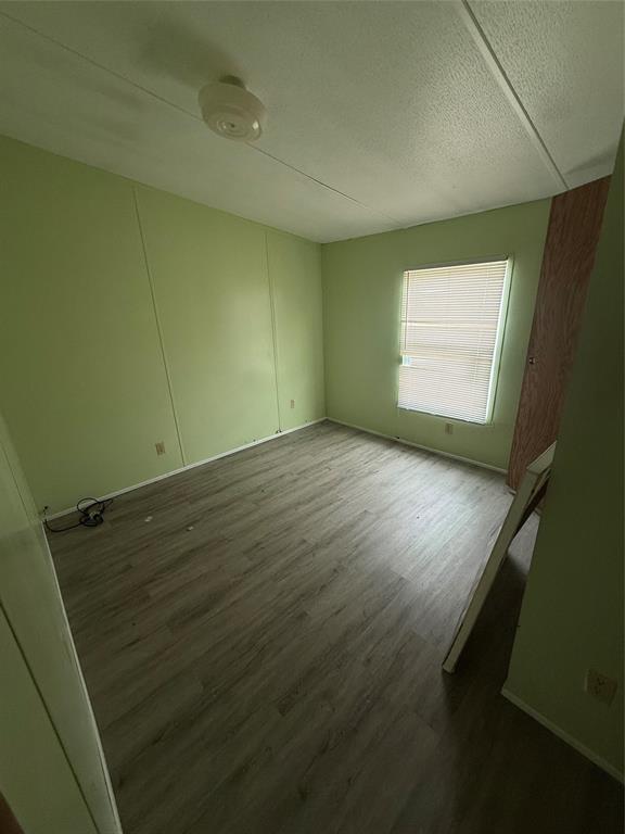118 Happy Trl Court Rhome, TX 76078 - Photo 9 of 9 an empty room with wooden floor and windows