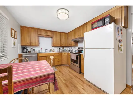 a kitchen with a refrigerator a stove top oven a sink and dishwasher