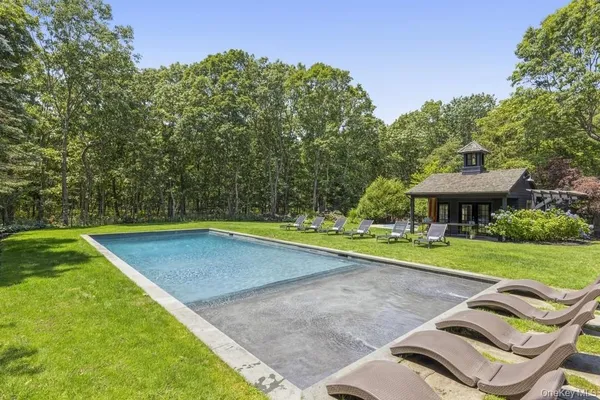 a view of a backyard with swimming pool