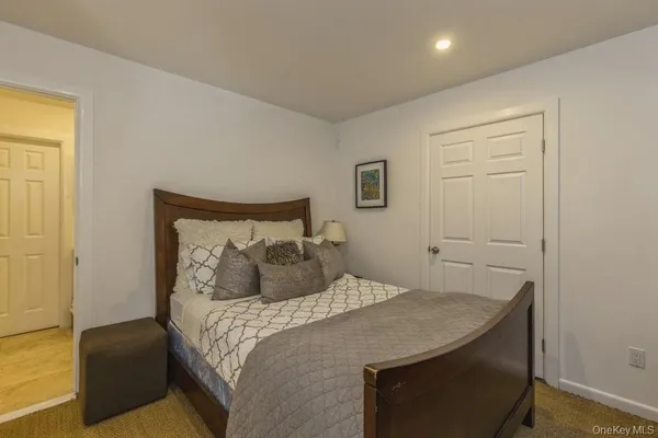 a bedroom with a bed and a night stand