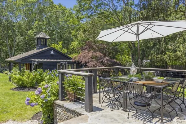 a patio with hardwood table and chairs
