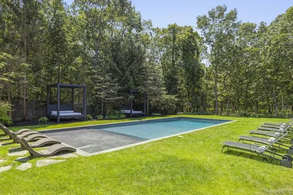 a view of a backyard with swimming pool