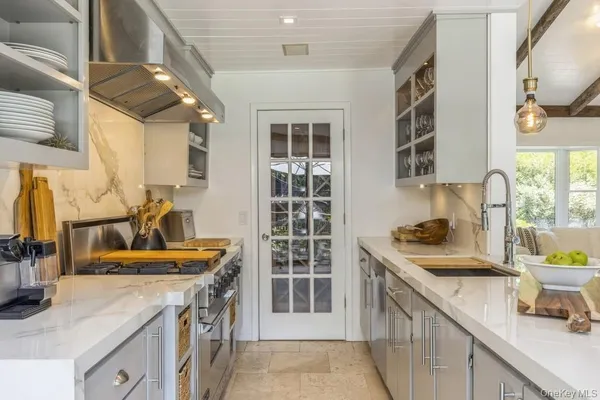a kitchen that has a sink and a stove in it