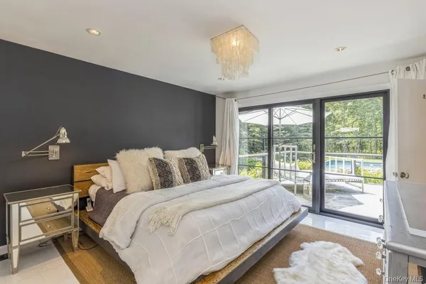 a bedroom with a large bed and a large window