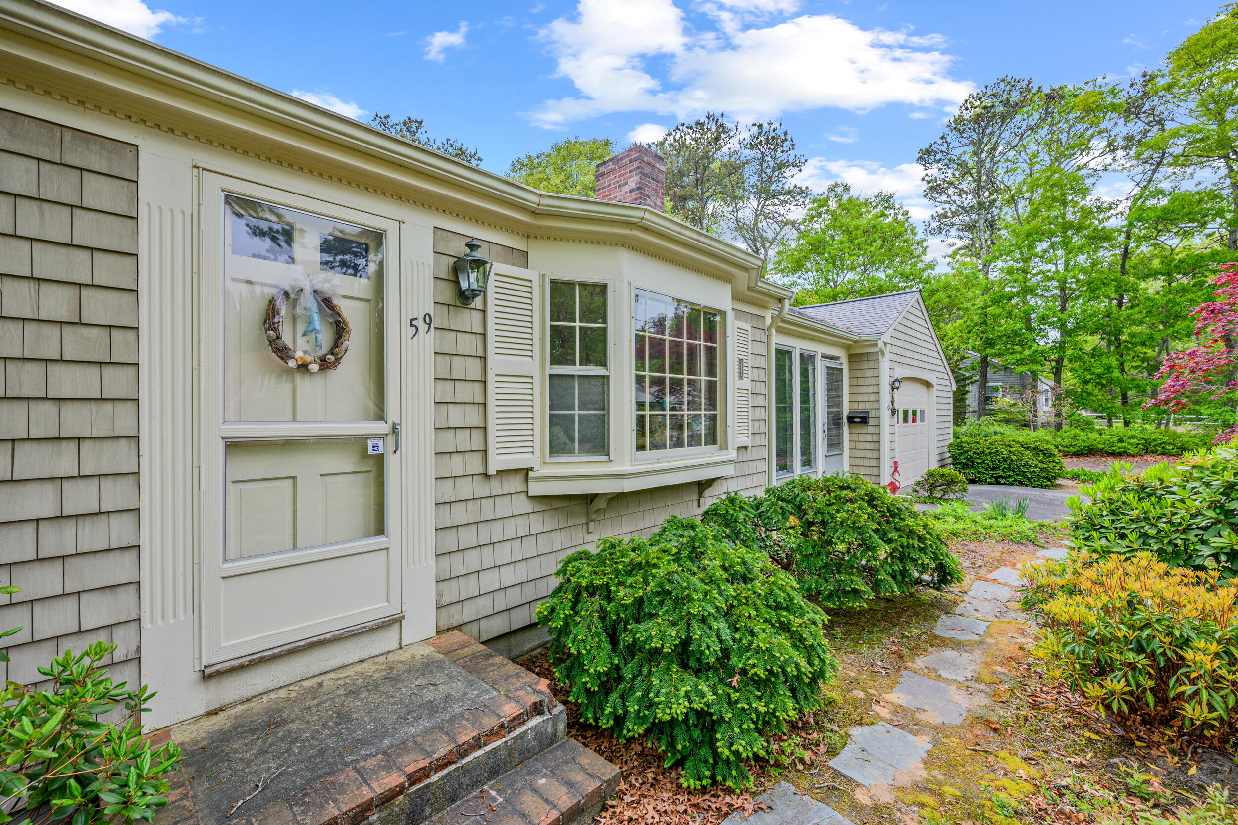 59 Beverly Road West Yarmouth, MA 02673 - Photo 5 of 33 a front view of a house with a garden