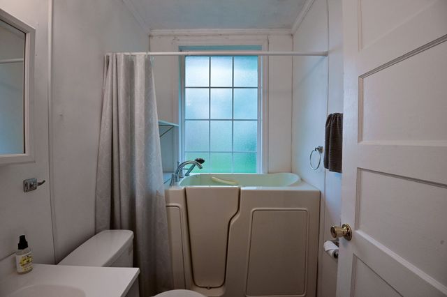 a bathroom with a sink a mirror and a toilet