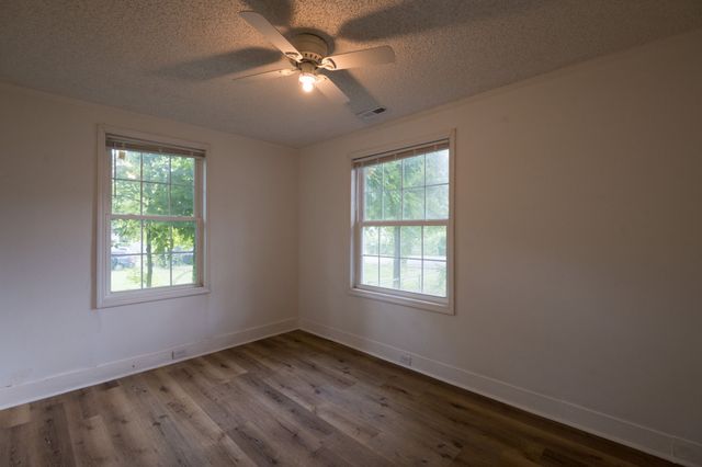 a view of a house with backyard and a garden