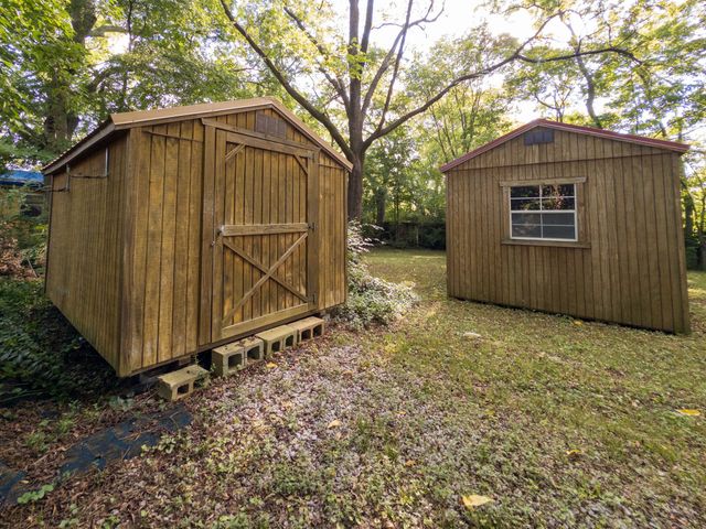 a view of a house with a tree back yard