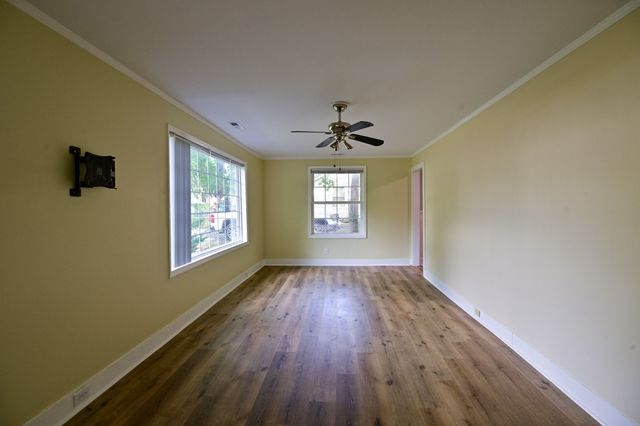 wooden floor in an empty room with a window