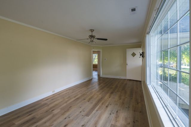 a view of an empty room and glass door