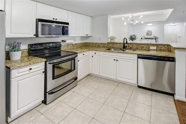 a kitchen with granite countertop cabinets and steel stainless steel appliances